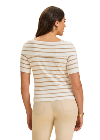 Woman wearing a striped shirt and beige pants on a beige background