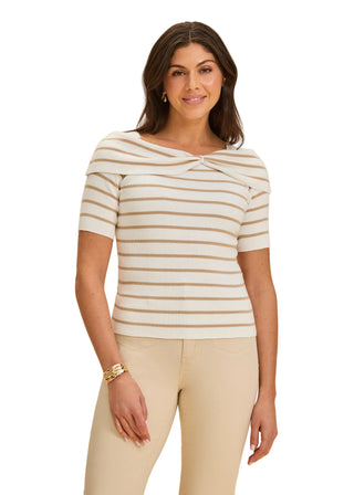 Woman wearing a striped shirt and beige pants against a beige background