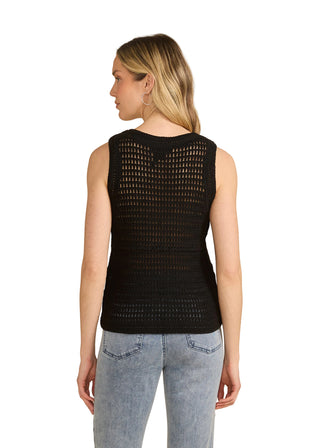 Woman wearing a black sleeveless top with a textured pattern on a beige background