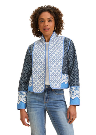 Woman wearing a blue patterned jacket on a beige background