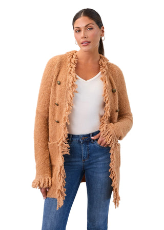 Woman wearing a beige cardigan with fringe details on a white background