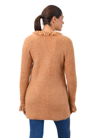 Woman wearing a brown fuzzy cardigan against a white background