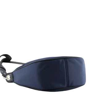 A navy blue nylon fanny pack with black trim and a black strap, shown from a side profile view against a light gray background.