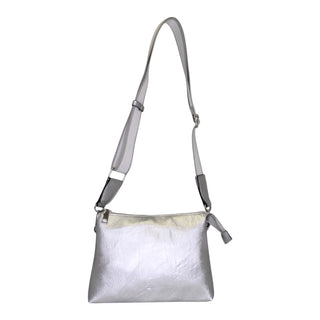 A metallic silver shoulder bag with a textured finish, featuring a matching adjustable shoulder strap and a small zippered pull tab, shown against a light gray background.