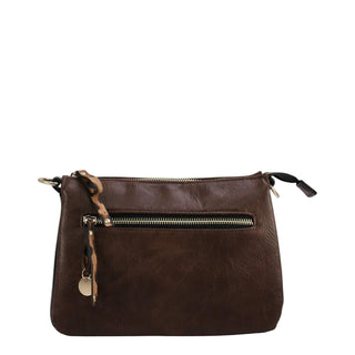 A dark brown leather crossbody bag with a front zippered pocket, gold-tone hardware, and a small hanging charm, shown against a light gray background.