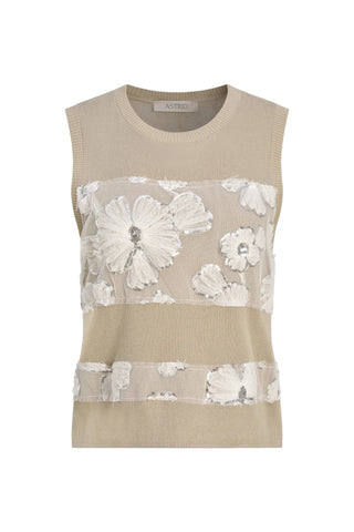 Beige sleeveless top with floral lace overlay on a light blue background