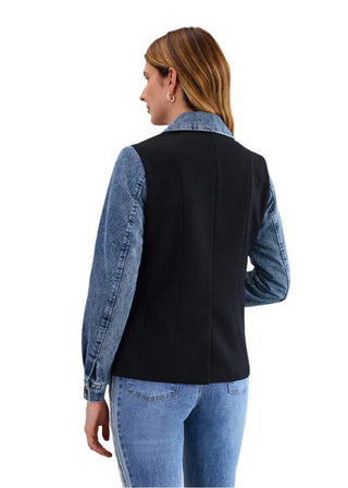 Woman wearing a black shirt with denim sleeves against a white background