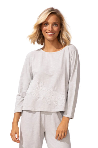 Woman wearing a light gray outfit on a white background