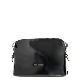 A glossy black patent leather crossbody bag with silver-tone hardware and the brand name 'THE TREND' printed in silver on the front, set against a plain light gray background.