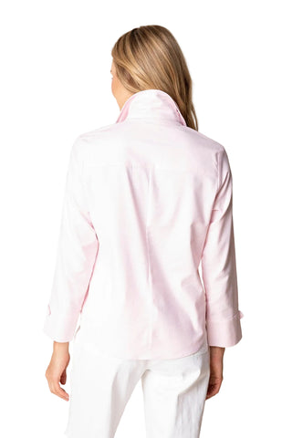 Person wearing a light pink shirt with a plain background