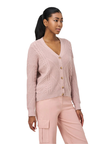 Woman wearing a pink cardigan and pants on a white background