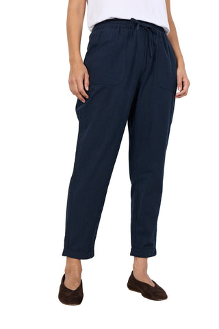 Navy blue pants worn by a person on a white background