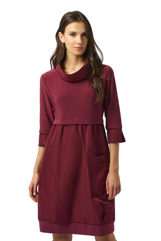 Woman wearing a burgundy dress on a white background