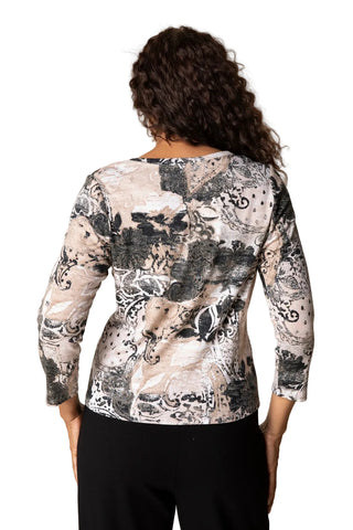 Person wearing a long-sleeve top with a nature-themed print on a plain background