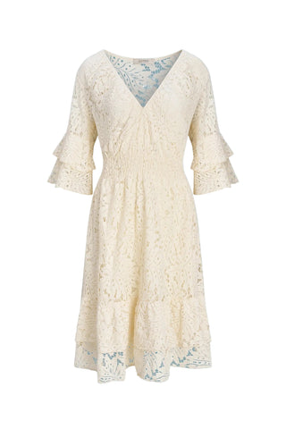 Cream lace dress on a light blue background