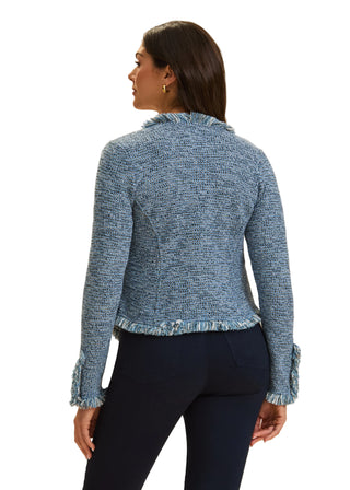 Woman wearing a blue textured sweater against a beige background