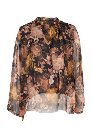 Floral patterned blouse with a sheer overlay on a white background