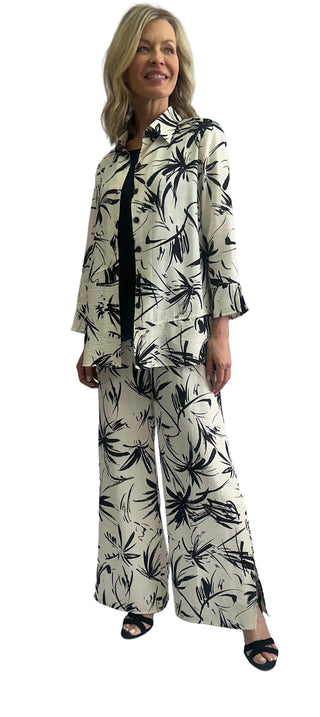 Woman wearing a black and white patterned outfit against a plain background