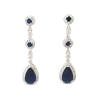 Pair of blue teardrop earrings with silver accents on a white background