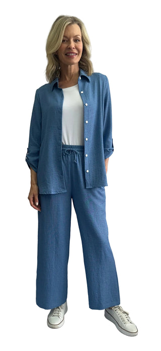 Woman wearing a blue outfit with a white background
