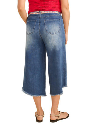 Person wearing blue jeans and a red top on a beige background