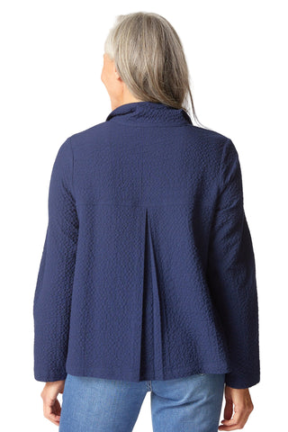 Person wearing a blue textured jacket on a white background
