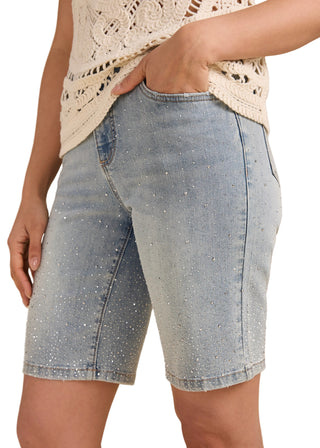 Denim shorts worn by a person on a beige background