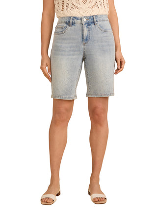 Person wearing light blue denim shorts on a beige background