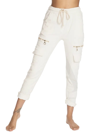 White jogger pants with zippers on a white background