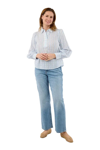 Woman wearing a striped shirt and light blue jeans on a white background