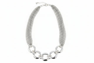 Silver chain necklace on a light pink background