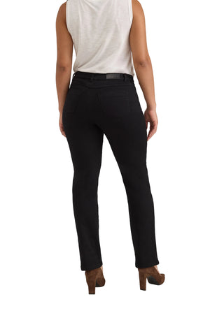 A model shown from the back wearing black slim-fit jeans, a white sleeveless top, and brown high-heeled shoes against a light gray studio background.