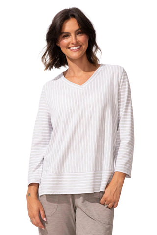 Woman wearing a white striped shirt on a white background