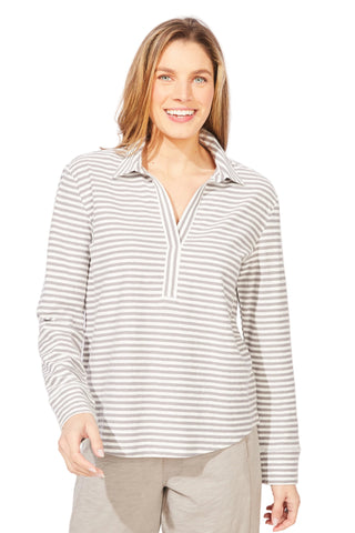 Woman wearing a striped long-sleeve shirt against a white background