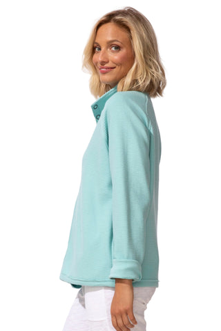 Woman wearing a light blue sweater on a white background