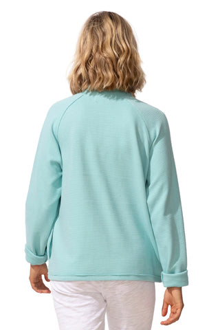 Person wearing a light blue textured sweater on a white background
