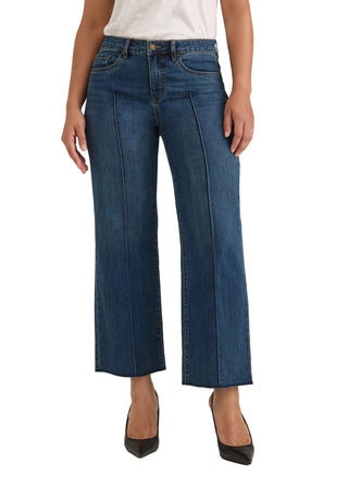 A model wearing a pair of dark blue cropped wide-leg denim jeans with front pleats, styled with a white top and black heels against a light gray studio background.