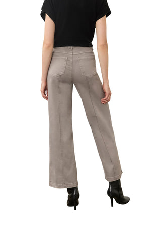 A model shown from the back wearing light gray wide-leg jeans, a black short-sleeve top, and black ankle boots, standing against a neutral studio background.