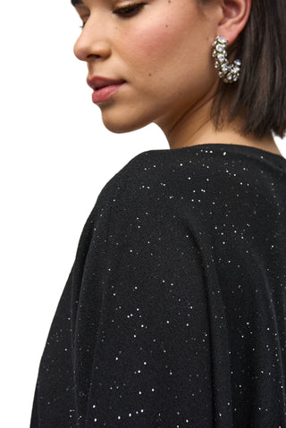 Black top with silver embellishments on a plain background