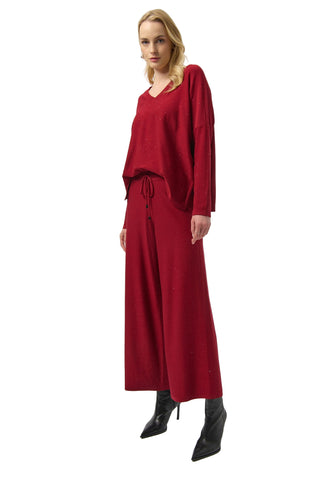 Woman wearing a red outfit on a white background
