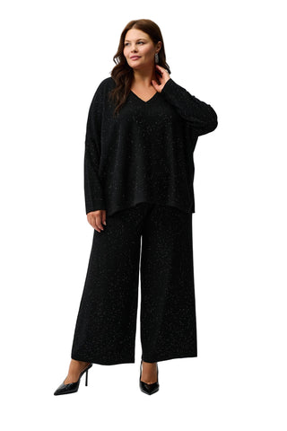 Woman wearing a black outfit on a white background