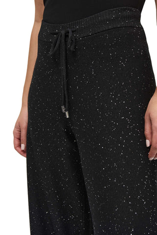 Black speckled pants with a drawstring on a white background