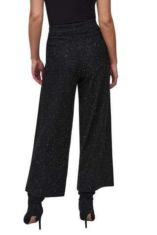 Black wide-leg pants worn by a person on a white background
