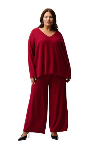 Woman wearing a red outfit on a white background