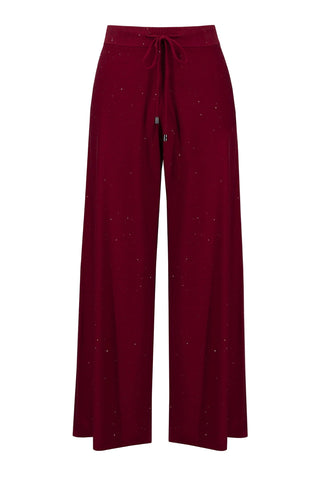Maroon pants with a tie waist on a light gray background