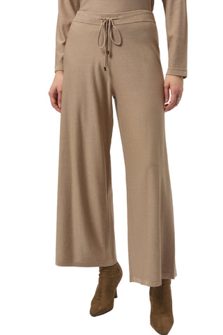 Beige pants worn by a person on a white background