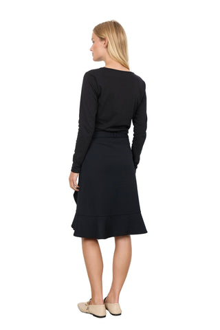 Woman wearing a black dress with a white background