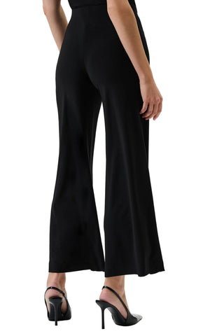 Black jumpsuit worn by a person on a white background