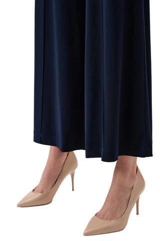Navy skirt and beige high-heeled shoes on a white background