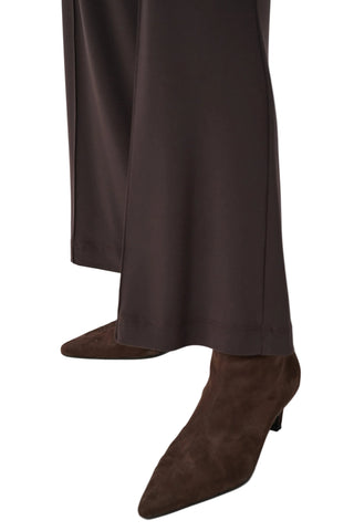 Brown suede boots and pants on a white background